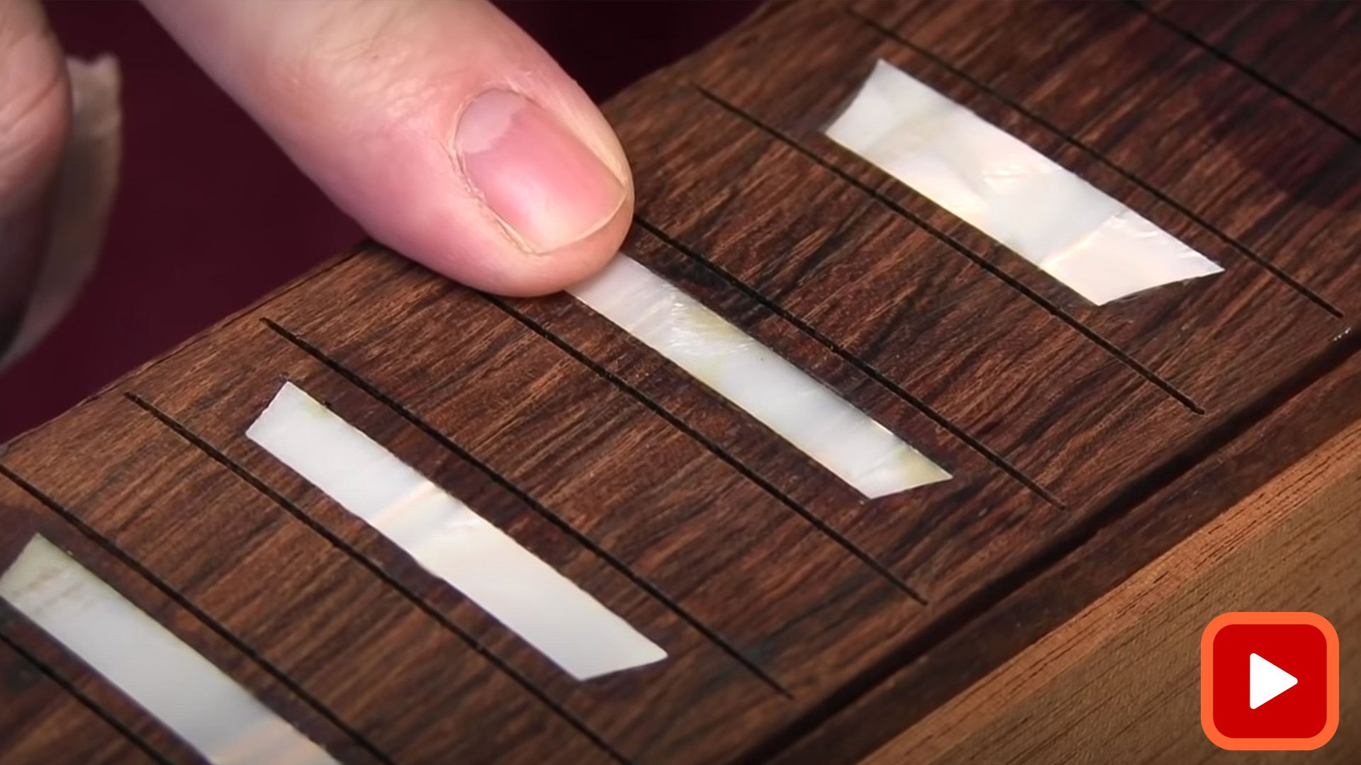 Finger pointing to inlay with no visible gaps